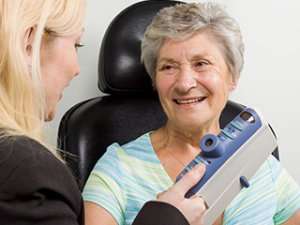 Image of an elderly woman getting a check-up. 