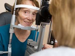 Image of an elderly woman getting an eye exam.